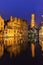 Belfry of Bruges reflected in the canal