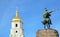 Belfry and monument in Kyiv sky