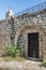 The belfry and the side door in the functioning church of the Christian Maronites in the abandoned village Kafr Birim in the north