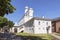 The belfry of St. Sophia Cathedral at the fortress wall with a building attached to it on the territory of the Kremlin in Veliky N