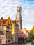 Belfry Tower and brick houses at water canal, Bruges, Belgium. HDR image