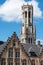 Belfry tower peeps over trep gable  in Bruges, Flanders, Belgium