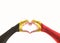 Belgian black yellow red flag pattern on people heart shaped hands clipping path on white background