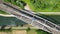 Belgian bridgescape: aerial view of train over river amidst forest