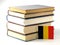 Belgian flag with pile of books on white background