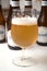 Belgian Hoegaarden of white bier in glass on bottles background