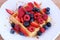 Belgian waffle with berries and syrup