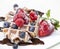 Belgian waffle with powdered sugar, chocolate syrup, and fruit o