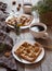Belgian waffles breakfast with nuts, honey, herbs and coffee.