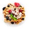 Belgian waffles with fresh berries and cream isolated on white