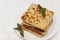 Belgian waffles with fresh mint on a white plate on a white tablecloth, retro toning, close-up