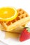 Belgian waffles,honey,orange and strawberries