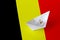 Belgium flag depicted on paper origami ship closeup. Handmade arts concept