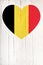 Belgium flag in heart shape on a white wooden board