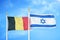 Belgium and Israel two flags on flagpoles and blue cloudy sky