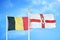 Belgium and Northern Ireland two flags on flagpoles and blue cloudy sky