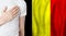 Belgium person with hand on heart on the background of Belgium flag. Patriotism, country, national, pride concept