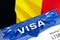 Belgium Visa in passport. USA immigration Visa for Belgium citizens focusing on word VISA. Travel Belgium visa in national