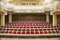 Belgorod, Russia - CIRCA january 2018: Empty huge hall interior with rows of red chairs and columns of philharmonic building