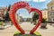 Belgorod, Russia. City environment. Bench of love in the shape of a heart with flower pots.