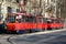 Belgrade red tram trolley carriages in sunlight Serbia