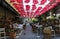 BELGRADE, SERBIA- JUNE 06, 2019: Red umbrellas above the open-air restaurant in King Peter street Belgrade, Serbia