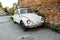 BELGRADE, SERBIA- JUNE 07, 2019: White Volkswagen Beetle retro car parked near a brick wall at the city street Belgrade, Serbia