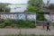 BELGRADE, SERBIA - MAY 8, 2017: People passing by a wall with an anti-american inscription on a wall: `Yankee go home`