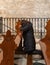 Believer woman kneels and prays in front of the altar in the main hall of the Chapel of Saint Catherine, in Bethlehem in the