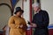 Believer woman talking to priest in church