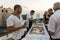 Believers treat visitors with sweets in the evening in the courtyard of the Ahmadiyya Shaykh Mahmud mosque in Haifa city in Israel