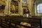 A believing woman sits on a bench in the church and prays to God. Girl praying in a church of Clerigos in Porto
