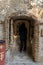 Believing woman stands and prays in front of the altar in the courtyard of the Monastery Deir Hijleh - Monastery of Gerasim of