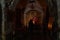 Believing woman stands and prays in front of the underground altar in the Monastery Deir Hijleh - Monastery of Gerasim of Jordan,