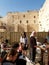 The believing women read religious books before the Wailing Wall