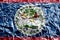 Belize flag depicted in paint colors on shiny crumpled aluminium foil closeup. Textured banner on rough background