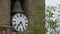 A bell and a clock in focus