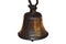 A bell is a hollow metal object shaped like a cup which has a piece hanging inside it that hits the sides and make a sound