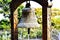 A bell is a hollow metal object shaped like a cup which has a piece hanging inside it that hits the sides and makes a sound.