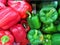 Bell pepper, sweet pepper or capsicum red and green color on shelf in supermarket with selective focus.