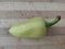 Bell pepper on a wooden surface. Fresh peppers on a cutting board. Bell peppers for salads, soups, pizza and ketchup.