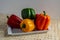 Bell peppers or peppers, of various colors, green, yellow and red, on a white plate, freshly cut, and moistened by rinsing them 2