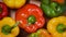 Bell peppers on rotating background. Top view. Vegan and raw food concept. Bright colors vegetables