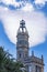 The bell tower of Ajuntament de ValÃ¨ncia with a blue sky with strange clouds along Placa Del Ajuntament, Valencia, Spain