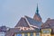 The bell tower and the apse of Martin`s Church  through the roofs of old houses in Old Town of Basel, Switzerland