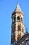 Bell tower of the Basilica del Santo in Padua, illuminated by the sun, close to sunset and silhouetted in the blue sky.