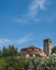 Bell tower of Cathedral of Santa Maria Assunta and Church of Santa Fosca over trees in Torcello, Venice, Italy