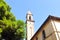 Bell tower of catholic church Chiesa di San Leopoldo in small town Vada on the coast of the Ligurian Sea.