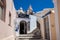 Bell tower of the Catholic Monastery of Dominican Nuns and beautiful alleys at Fira City in