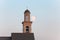 The bell tower of a church at dusk with a big moon close/bell to